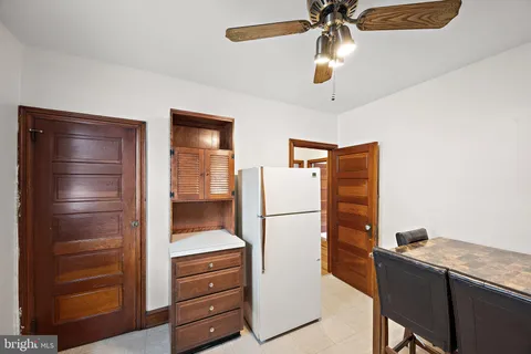 a kitchen with a refrigerator and cabinets
