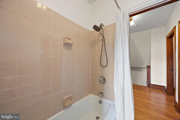 a bathroom with a shower and a bathtub