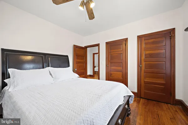 a bedroom with a large bed and a chandelier