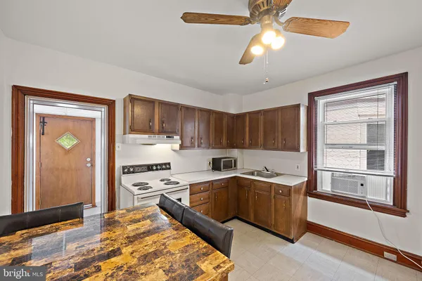 a kitchen with stainless steel appliances granite countertop a sink cabinets and wooden floor