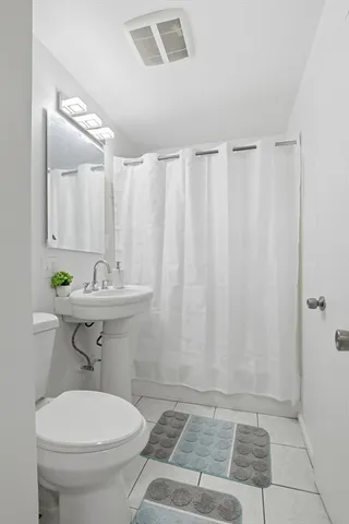 a bathroom with a sink a toilet and a shower