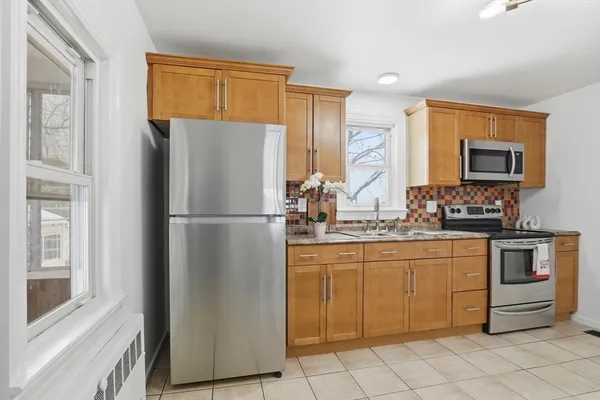 a kitchen with stainless steel appliances granite countertop a refrigerator and a stove top oven
