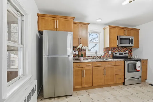 a kitchen with stainless steel appliances granite countertop a refrigerator and a stove top oven