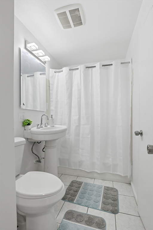 39 Phebe Avenue Lowell, MA 01854 - Photo 9 of 20 a bathroom with a sink a toilet and a shower