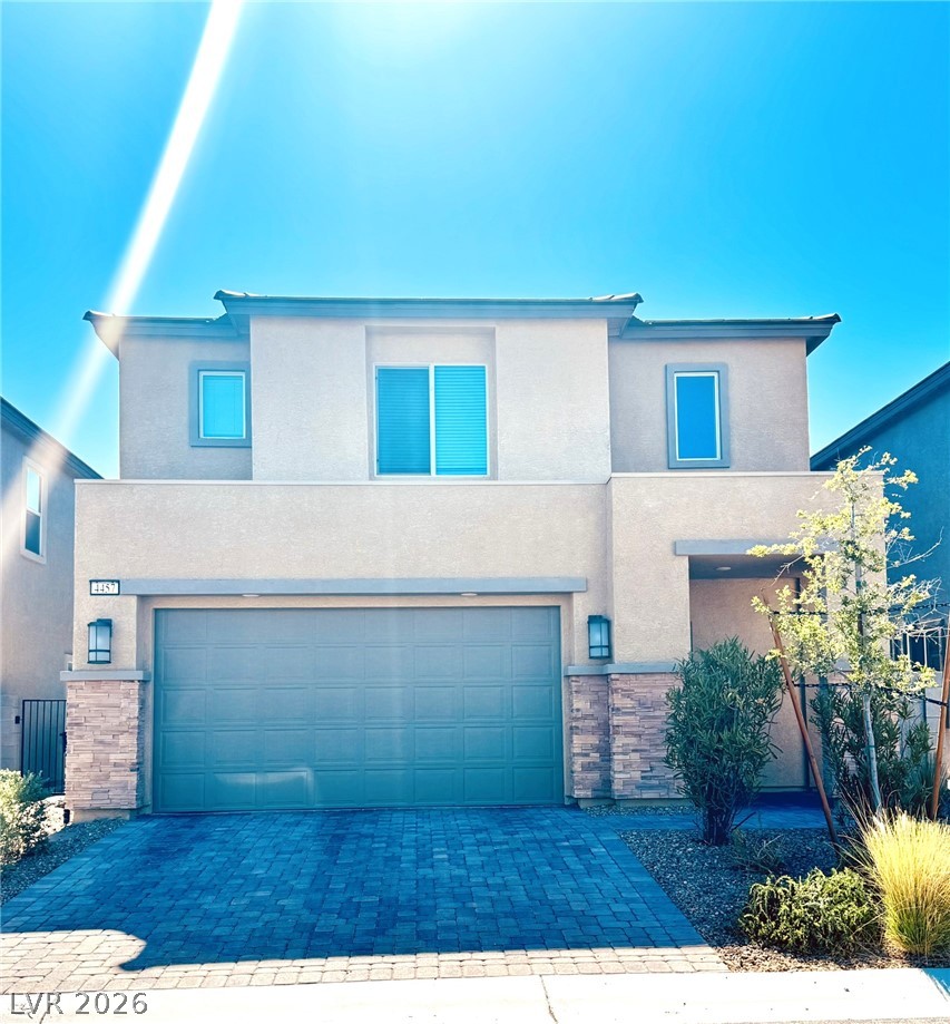4457 Sawyer Ridge Street Las Vegas, NV 89147 - Photo 1 of 32 A modern facade with a striking paved driveway leads to a welcoming entry.