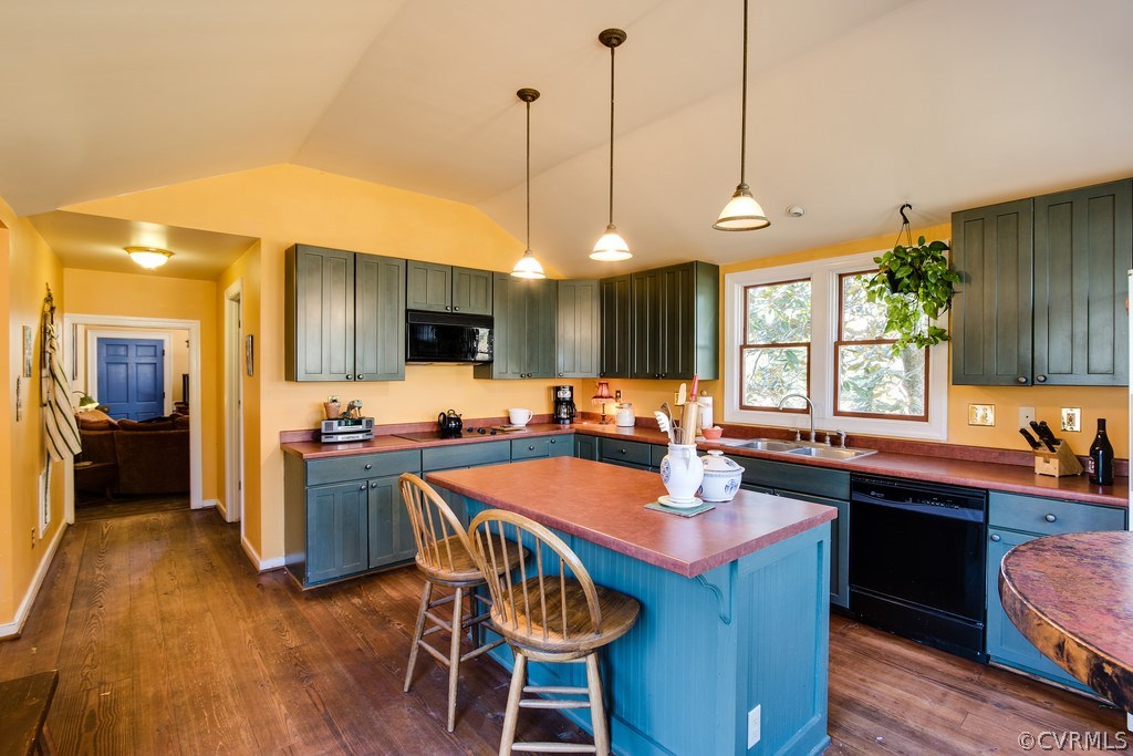 12016 Old Buckingham Road Midlothian, VA 23113 - Photo 14 of 24 a kitchen with a dining table chairs sink and wooden floor