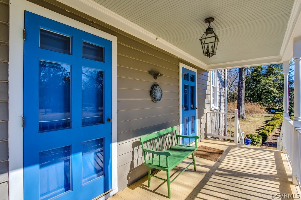 12016 Old Buckingham Road Midlothian, VA 23113 - Photo 4 of 24 a view of a porch with a table and chairs