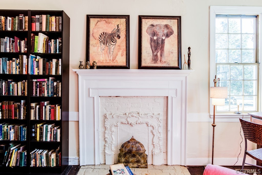 12016 Old Buckingham Road Midlothian, VA 23113 - Photo 9 of 24 a room with lots of books on the wall and a painting on the wall