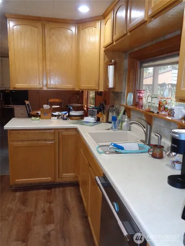 a kitchen with a sink a stove cabinets and a dining table
