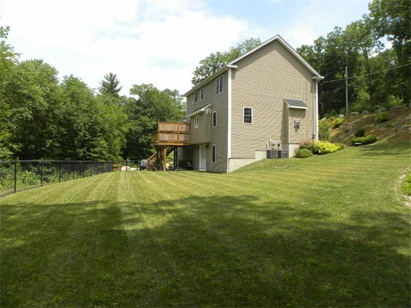 52 Baker Pond Road Charlton, MA 01507 - Photo 2 of 30 a view of a house with a yard patio and fire pit