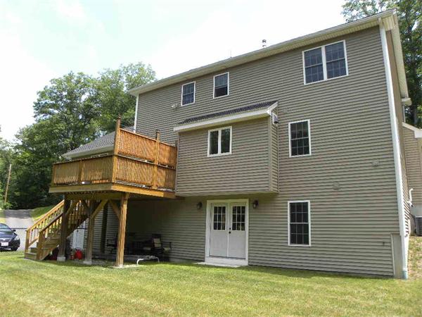 52 Baker Pond Road Charlton, MA 01507 - Photo 25 of 30 a view of a house with a yard and furniture