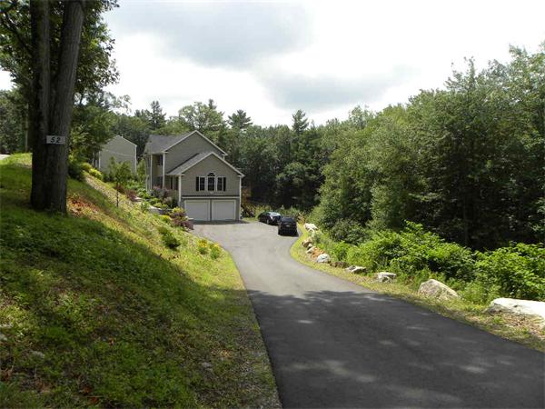 52 Baker Pond Road Charlton, MA 01507 - Photo 27 of 30 a house with green field in front of it