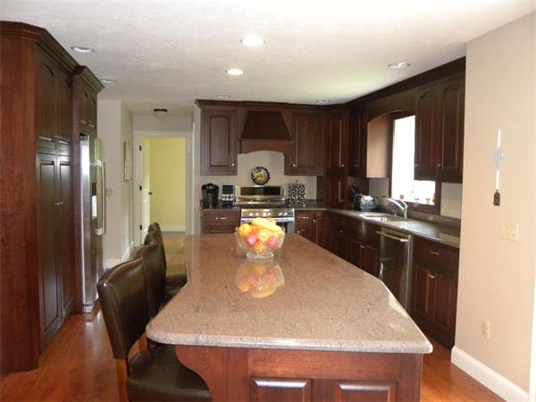 52 Baker Pond Road Charlton, MA 01507 - Photo 4 of 30 a kitchen with a table chairs and refrigerator