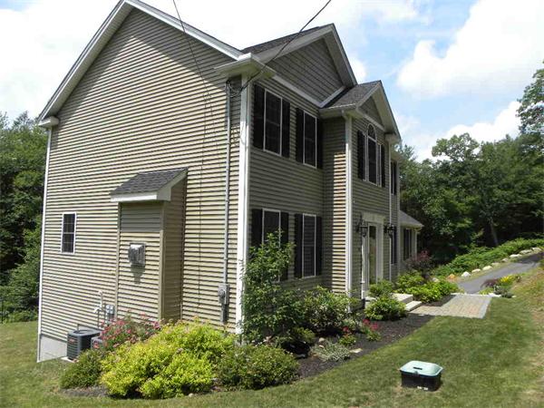 52 Baker Pond Road Charlton, MA 01507 - Photo 5 of 30 a front view of a house with garden