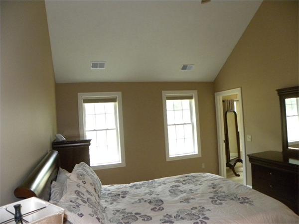 52 Baker Pond Road Charlton, MA 01507 - Photo 10 of 30 a bedroom with a bed and a dresser next to a window