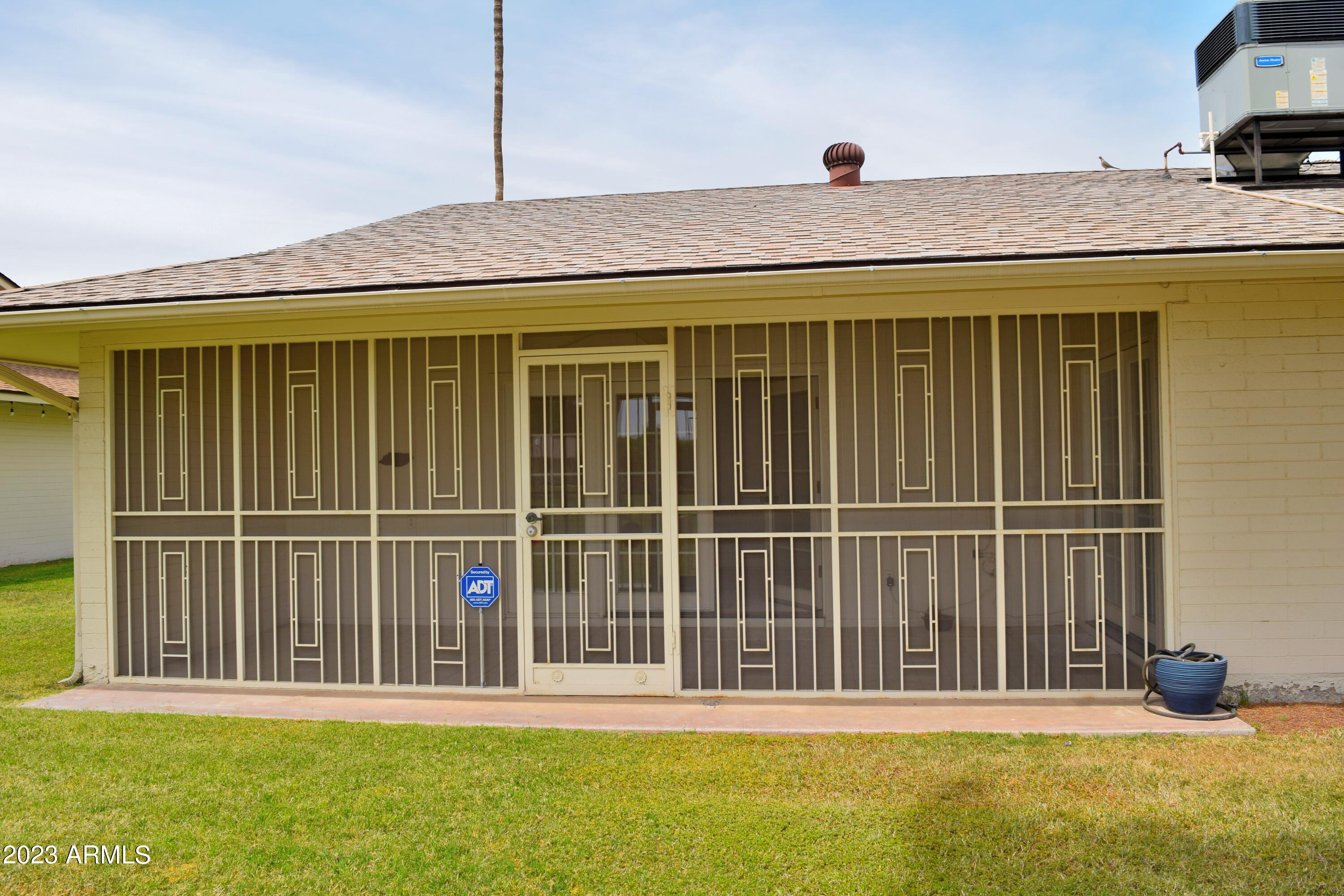 10705 West Hatcher Road Sun City, AZ 85351 - Photo 25 of 29 Screened in Secure Patio South