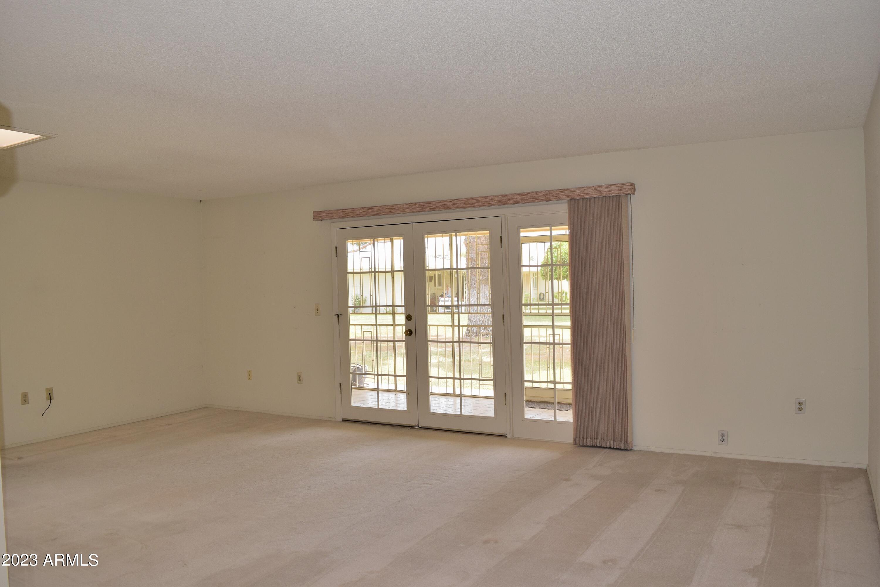 10705 West Hatcher Road Sun City, AZ 85351 - Photo 9 of 29 French Doors to Screened Patio