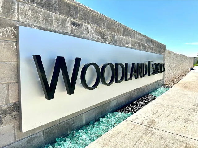 a wooden sign on the wall of building