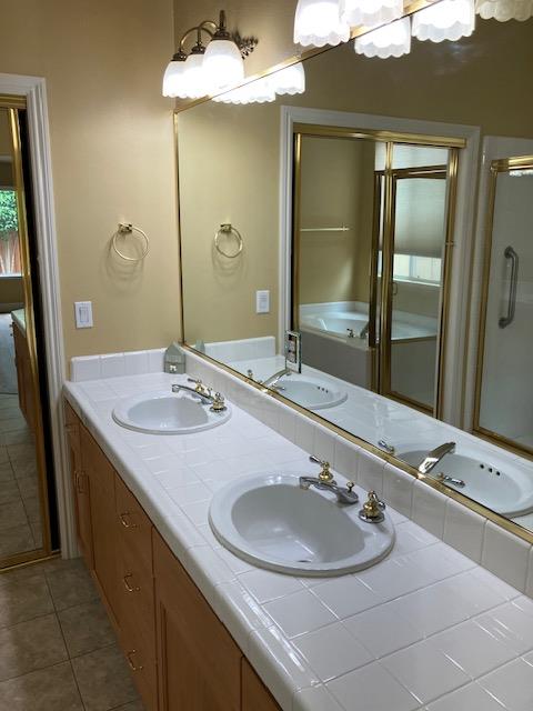2157 West Rue St Michel Fresno, CA 93711 - Photo 12 of 22 a bathroom with a sink and a mirror