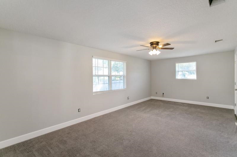 347 Lobelia Road St. Augustine, FL 32086 - Photo 11 of 40 an empty room with windows and chandelier fan