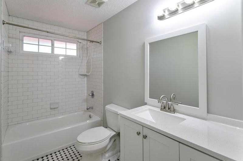 347 Lobelia Road St. Augustine, FL 32086 - Photo 20 of 40 a bathroom with a granite countertop sink a toilet and shower