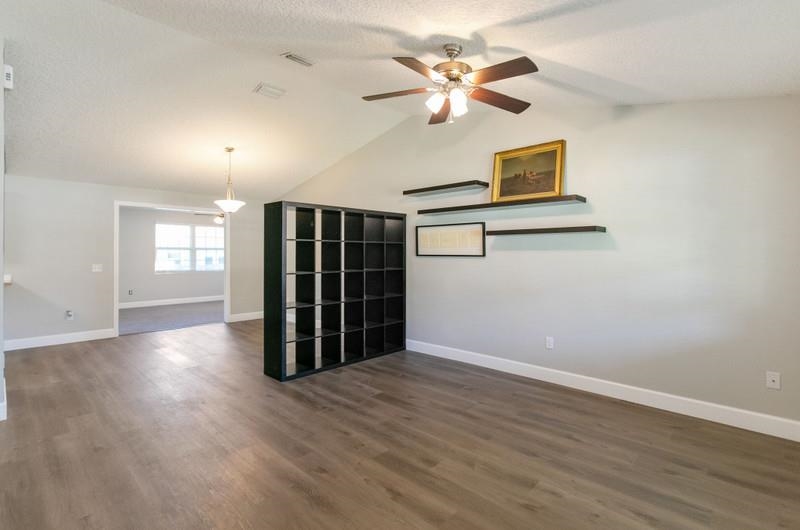 347 Lobelia Road St. Augustine, FL 32086 - Photo 3 of 40 a view of an empty room with a window and wooden floor
