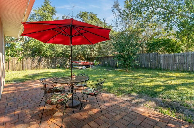347 Lobelia Road St. Augustine, FL 32086 - Photo 28 of 40 a view of a table and chairs under an umbrella