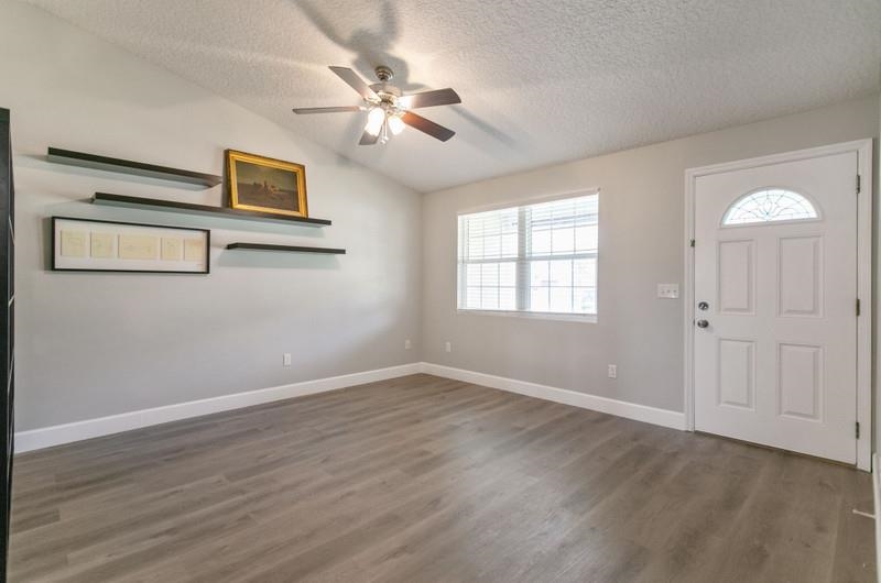 347 Lobelia Road St. Augustine, FL 32086 - Photo 4 of 40 a view of an empty room with wooden floor and window