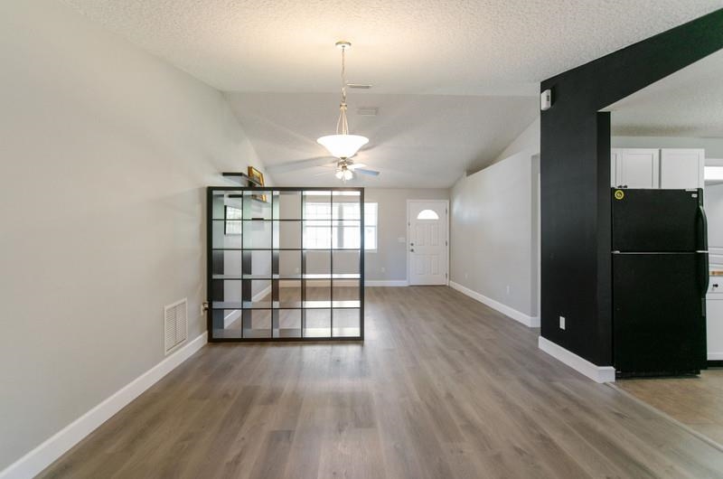 347 Lobelia Road St. Augustine, FL 32086 - Photo 6 of 40 wooden floor in an empty room with a window