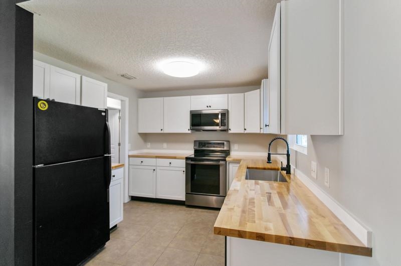 347 Lobelia Road St. Augustine, FL 32086 - Photo 7 of 40 a kitchen with a refrigerator a stove top oven a sink and dishwasher
