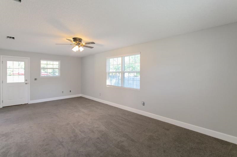 347 Lobelia Road St. Augustine, FL 32086 - Photo 10 of 40 an empty room with windows and chandelier fan