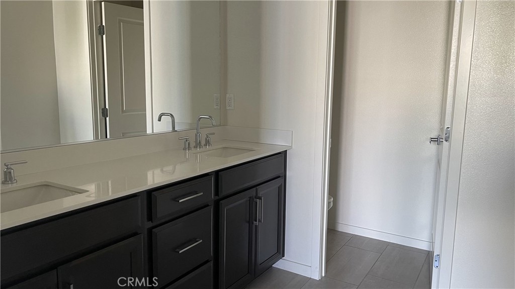 115 Citysquare Irvine, CA 92614 - Photo 15 of 30 a bathroom with a sink and a mirror