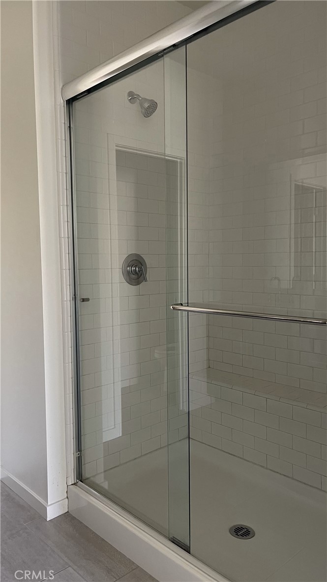 115 Citysquare Irvine, CA 92614 - Photo 16 of 30 a bathroom with a glass shower door