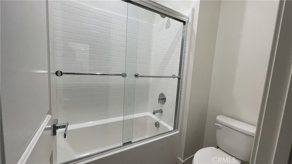 115 Citysquare Irvine, CA 92614 - Photo 17 of 30 a bathroom with a shower and a toilet