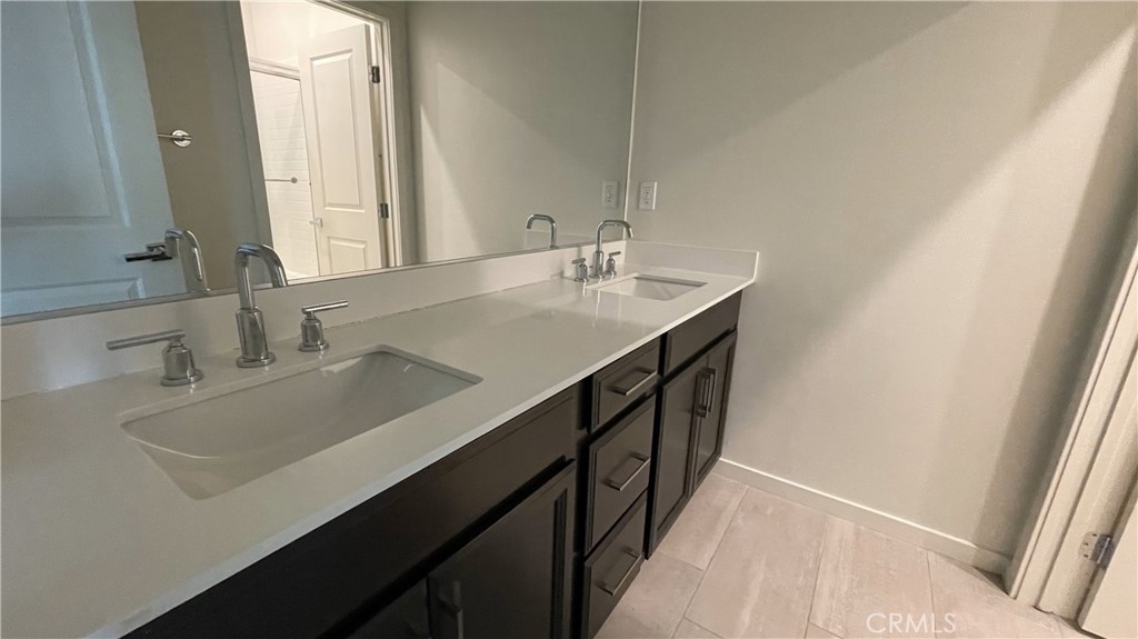 115 Citysquare Irvine, CA 92614 - Photo 18 of 30 a bathroom with a sink and a mirror