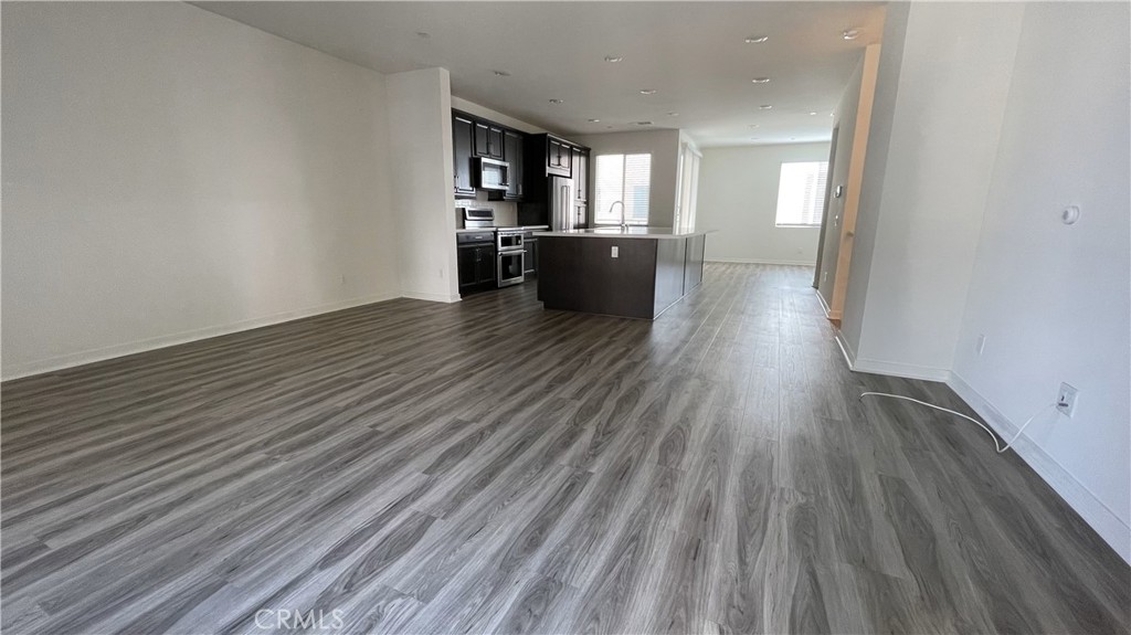 115 Citysquare Irvine, CA 92614 - Photo 26 of 30 a view of empty room with wooden floor and windows