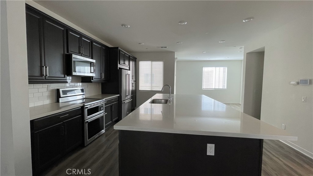 115 Citysquare Irvine, CA 92614 - Photo 5 of 30 a kitchen with stainless steel appliances a sink stove and microwave