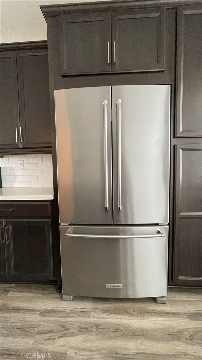 115 Citysquare Irvine, CA 92614 - Photo 9 of 30 a close view of a refrigerator in kitchen with stainless steel appliances wooden cabinet