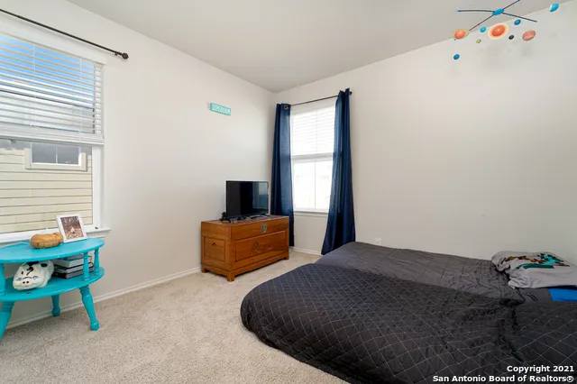 a bedroom with furniture and a window