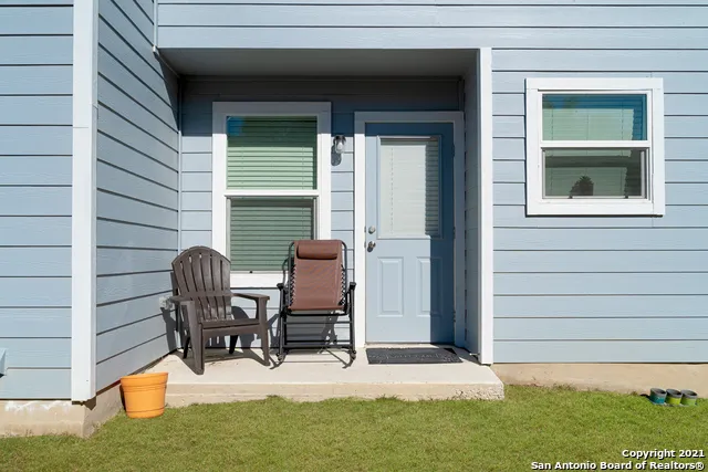 a view of backyard with a chair and table in patio