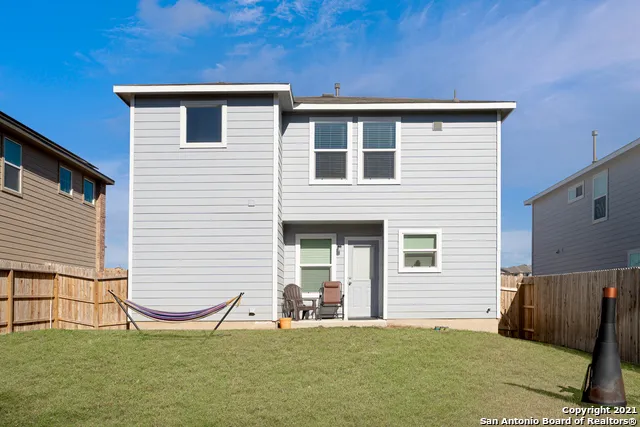 a view of a house with backyard and porch