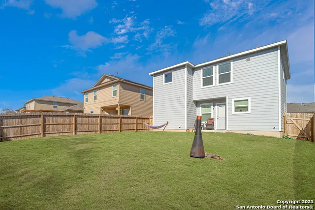 a backyard of a house with table and chairs