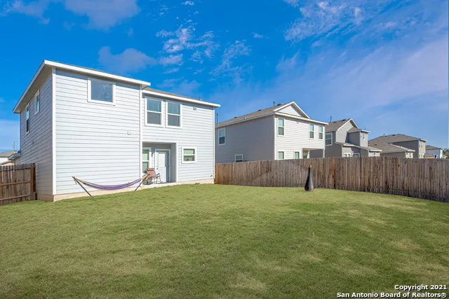 a view of a house with a yard and a garage