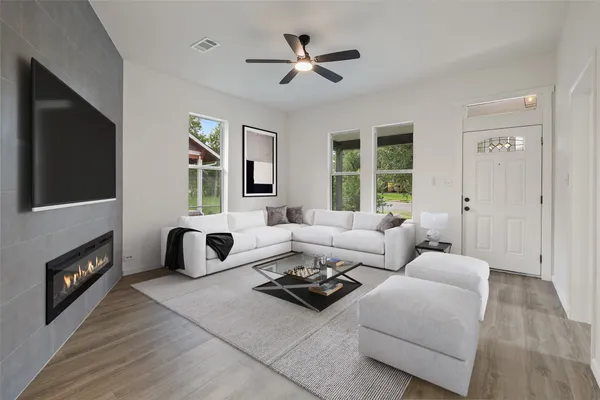 a living room with furniture fireplace and a flat screen tv
