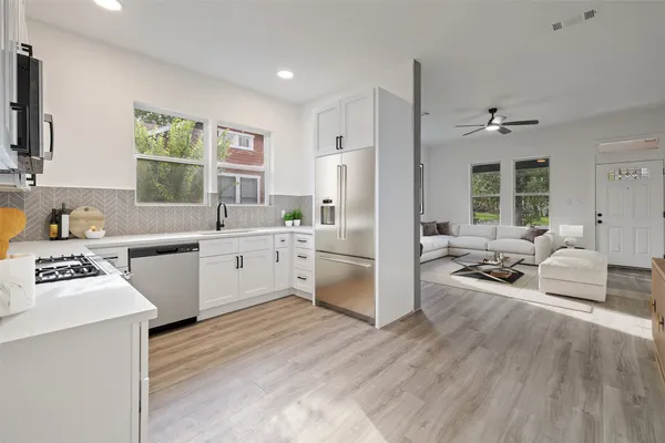 a kitchen with a sink appliances and cabinets
