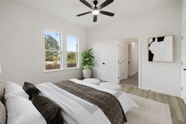 a bedroom with a large bed and a window