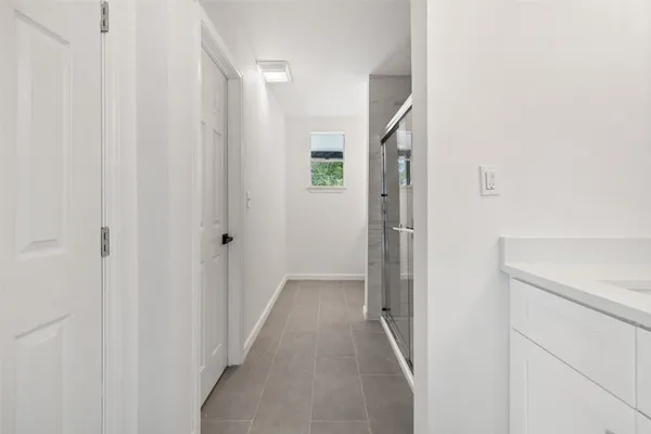 a view of a hallway with wooden shelves