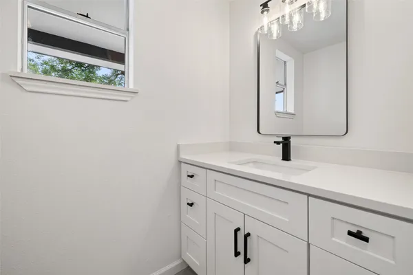 a bathroom with a sink and vanity