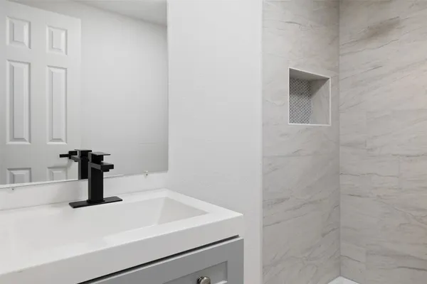a bathroom with a sink and vanity