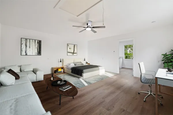 a living room with furniture and a wooden floor